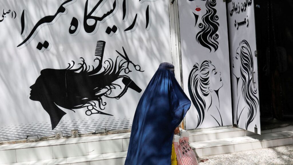 An Afghan woman walks past a beauty salon in Kabul, Afghanistan, July 6, 2023. (Reuters File)