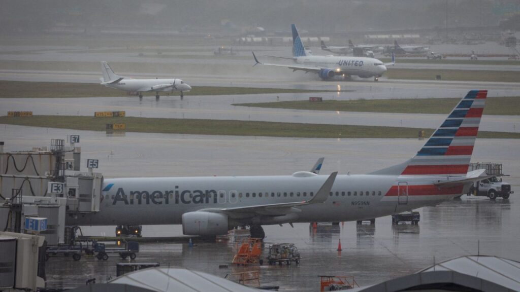 An American Airlines airplane sits parked at Fort Lauderdale - Hollywood International Airport as a United Airlines flight lands, in Fort Lauderdale, Florida, U.S., April 23, 2026. (Reuters/Marco Bello)