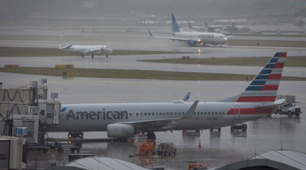 An American Airlines airplane sits parked at Fort Lauderdale - Hollywood International Airport as a United Airlines flight lands, in Fort Lauderdale, Florida, U.S., April 23, 2026. (Reuters/Marco Bello)