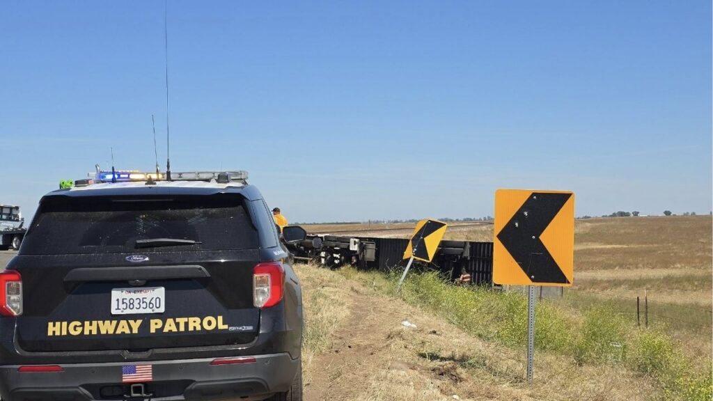 An overturned big rig near Marguerite Road and Santa Fe Avenue caused traffic delays Tuesday morning as recovery crews prepared to remove the vehicle. (CHP)