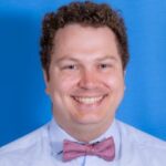 Image if UCSF Fresno's Benjamin Hopkins. He's wearing a blue shirt and a red checked bow tie