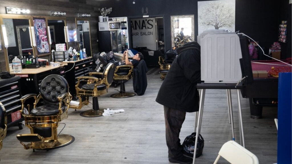 Kevin Stull, right, fills out his ballot as Bryan Diaz waits to give a haircut at Ana’s Hair Salon, which was acting as a polling place, on primary election day in San Francisco, on June 2, 2026. Voters rejected more local taxes than usual in the June election, a sign that they are feeling the pinch from rising costs. (Minh Connors/The New York Times)
