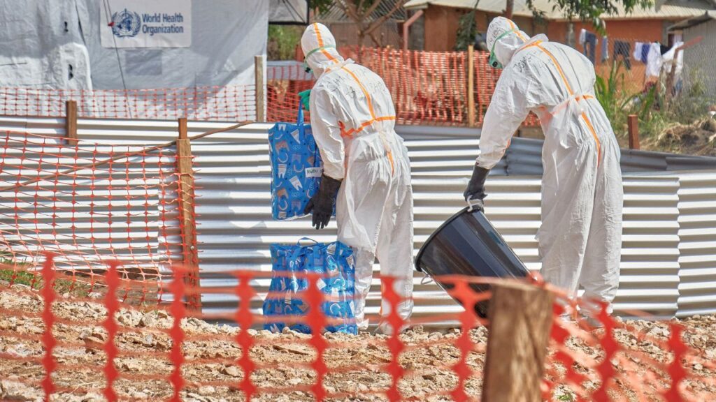 Congolese medical workers dressed in personal protective equipment (PPE) handle bags at the Centre Medical Evangelique (CME) within the secured Ebola response zone, as aid agencies intensify efforts to contain the Ebola outbreak involving the Bundibugyo strain, in Hoho commune of Bunia town, Ituri province, Democratic Republic of Congo, June 9, 2026. (Reuters/Gradel Muyisa Mumbere)