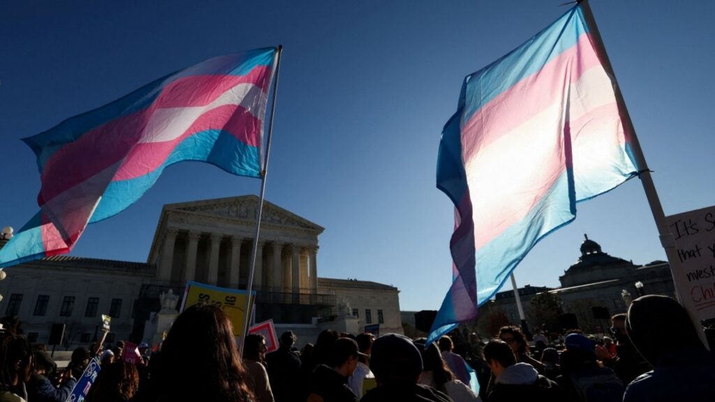 Demonstrators carry a transgender flags outside the U.S. Supreme Court, on the day justices are expected to hear oral arguments in two cases concerning efforts to enforce Republican-backed state laws banning transgender athletes from female sports teams at public schools, in Washington, D.C., U.S., January 13, 2026. (Reuters File)