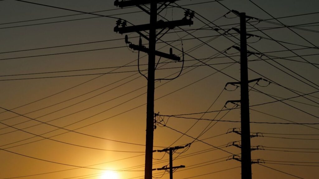 Electrical transmission poles and lines are shown in the early morning of a hot summer day in Commerce, California, U.S, August 7, 2025. (Reuters/Mike Blake)