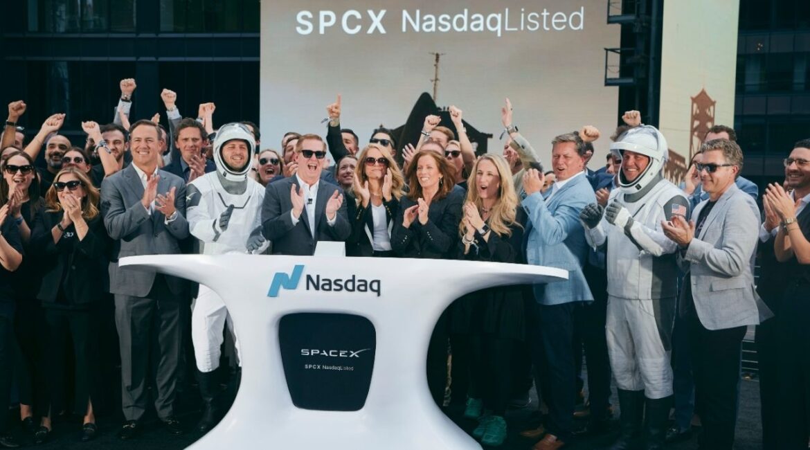 Executives and amployees of SpaceX, including the chief financial officer Bret Johnson, near center in sunglasses, and others dressed as astronauts, cheer the closing bell at the Nasdaq stock exchange in midtown Manhattan on Friday, June 12, 2026. SpaceX’s share price continued to surge on Monday, the company’s first full day of trading, adding to its sharp move higher on Friday after its record-breaking public listing. (Andres Kudacki/The New York Times)