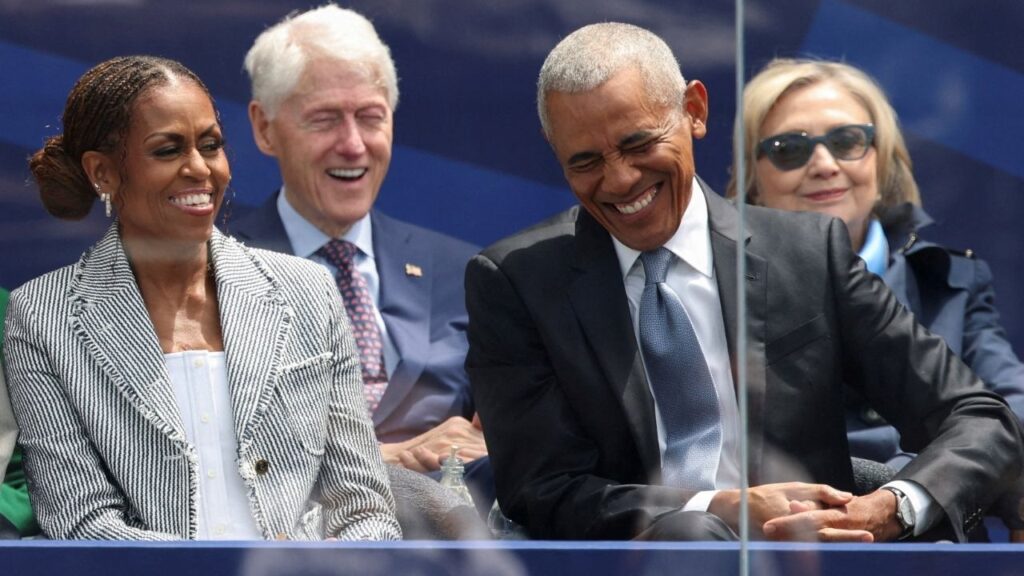 Former U.S. President Barack Obama and Michelle Obama laugh as they attend a dedication ceremony for the opening of the Obama Presidential Center, in Chicago, Illinois, U.S., June 18, 2026. (Reuters/Brendan McDermid)
