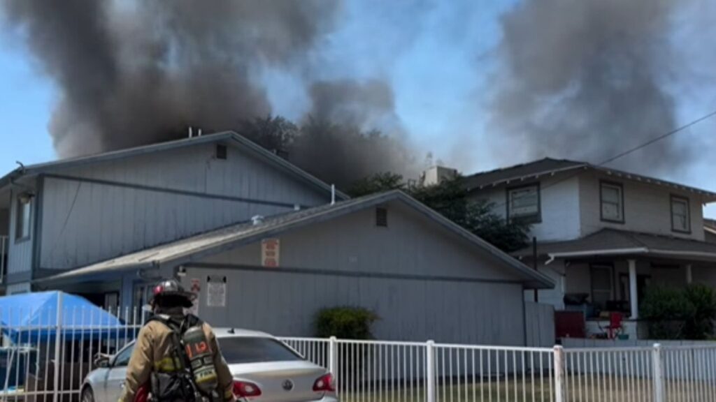 Fresno firefighters extinguished a garage fire on N. Calaveras St. that spread to nearby trees and briefly threatened homes and an apartment complex, with no injuries reported. (Fresno FD)