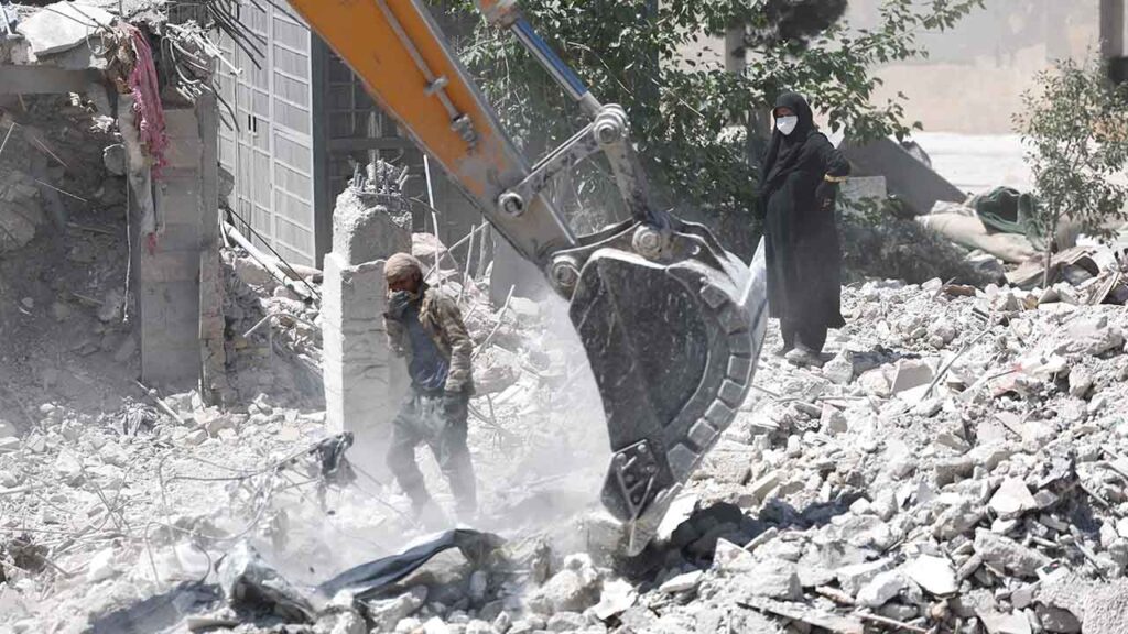 A woman stands among the rubble of her house, which was damaged in a U.S. and Israeli strike in March, in Tehran, Iran June 7, 2026. (Majid Asgaripour/WANA (West Asia News Agency) via Reuters)