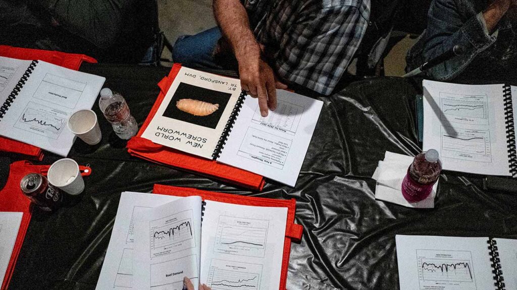 Paul Janda, a cattle rancher from Schulenburg, Texas, examines documents covering economics and the threat of the New World Screwworm parasite during the Fayette County Cow/Calf Clinic and Trade Show in La Grange, Texas, U.S., May 1, 2026. (Reuters/File Photo)