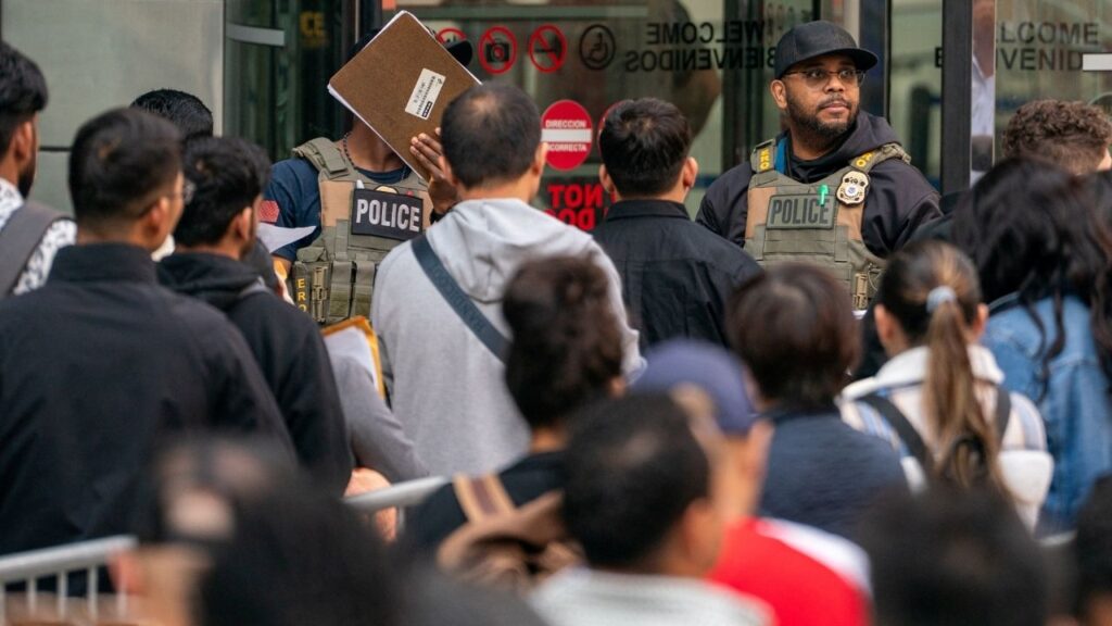 ICE agents speak to people lined up to enter the U.S. Immigration Court, in Manhattan, New York City, U.S., June 5, 2025. (Reuters/David 'Dee' Delgado)