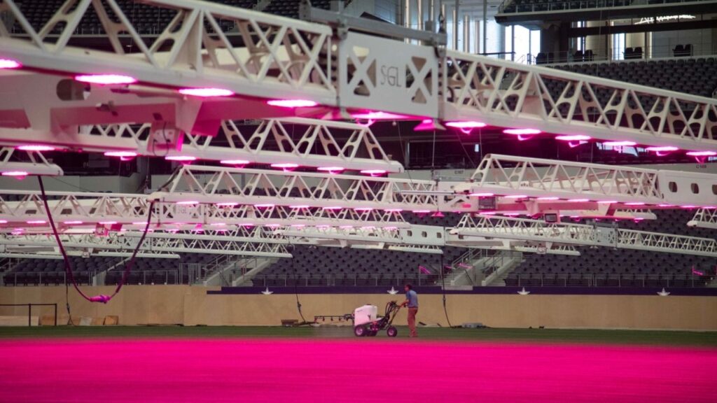 In an image provided by the Dallas Host Committee, Watering equipment and LED lighting for the sod for the FIFA World Cup, at Dallas Stadium. Every match must be played on natural grass that gives players as consistent a surface as possible, no matter the venue. Cue the years of sod studies. (Dallas Host Committee via The New York Times)