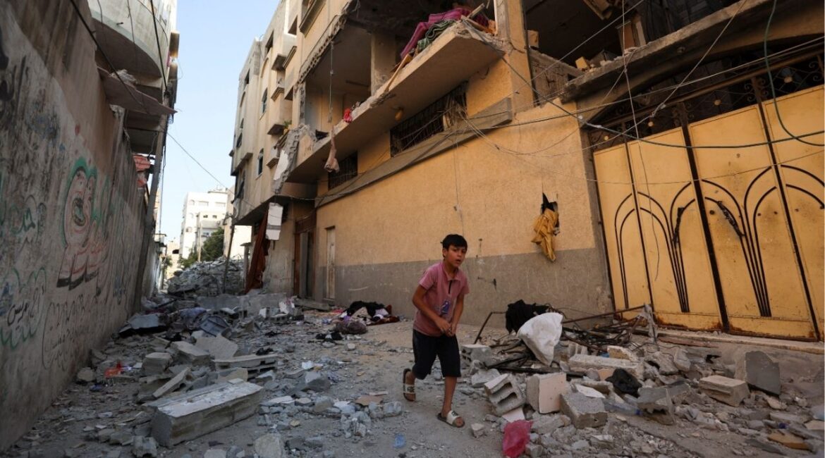 A Palestinian boy runs past the site of an Israeli strike on an apartment in Gaza City, June 20, 2026. Reuters/Dawoud Abu Alkas