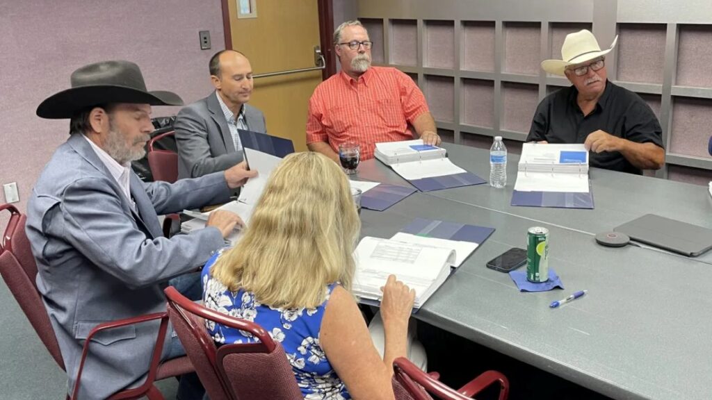 Image of board members sitting around a table