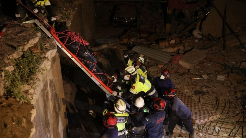 Members of Ecuadorian ECU-11 Guayaquil Fire Department and Portuguese firefighters recover the body of a casualty from a building that collapsed from the ground floor to the fifth floor, following major earthquakes, in La Guaira, Venezuela, June 29, 2026. REUTERS/Leonardo Fernandez Viloria