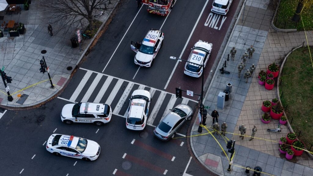 Members of the National Guard gather on a corner near the scene where two members of the National Guard were shot in Washington, Nov. 26, 2025. Prosecutors on Tuesday, June 16, 2026, unveiled federal murder charges against the man charged with opening fire on members of the National Guard in Washington last year, raising the possibility that the government could seek the death penalty if he is convicted. (Eric Lee/The New York Times)