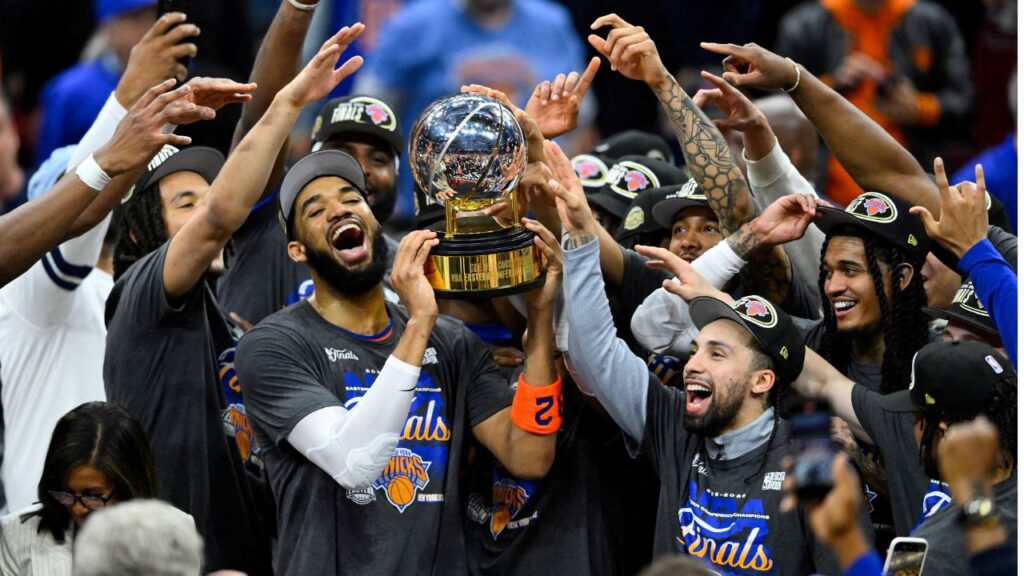 May 25, 2026; Cleveland, Ohio, USA; New York Knicks center Karl-Anthony Towns (32) lifts the 2026 Eastern Conference trophy with teammates after defeating the Cleveland Cavaliers in game four of the eastern conference finals for the 2026 NBA playoffs at Rocket Arena. (Mandatory Credit: David Richard-Imagn Images/File Photo)