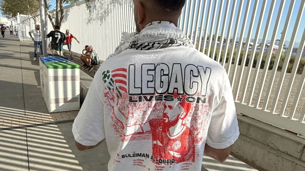 Omar Khalid wears a T-shirt featuring one of Palestinian soccer’s most revered players, Suleiman Al-Obeid, who died following an Israeli attack in southern Gaza in 2025, in Santa Clara, Calif., June 22, 2026. Jordan’s first qualification for the World Cup also means a World Cup berth for Palestinians, millions of whom live in the country. (Tariq Panja/The New York Times)