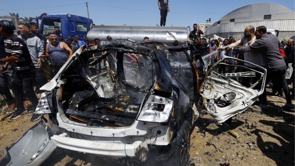 Palestinians gather at the site of an Israeli strike on a vehicle, in Deir al-Balah, in the central Gaza Strip June 2, 2026. (Reuters/Mahmoud Issa)
