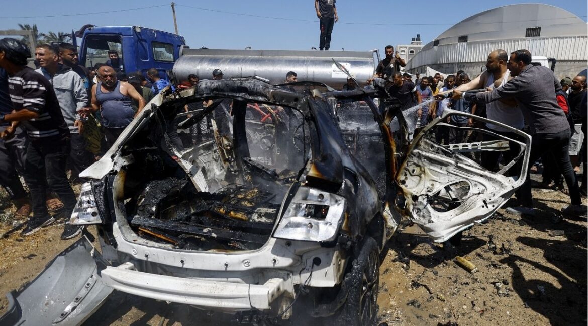 Palestinians gather at the site of an Israeli strike on a vehicle, in Deir al-Balah, in the central Gaza Strip June 2, 2026. (Reuters/Mahmoud Issa)