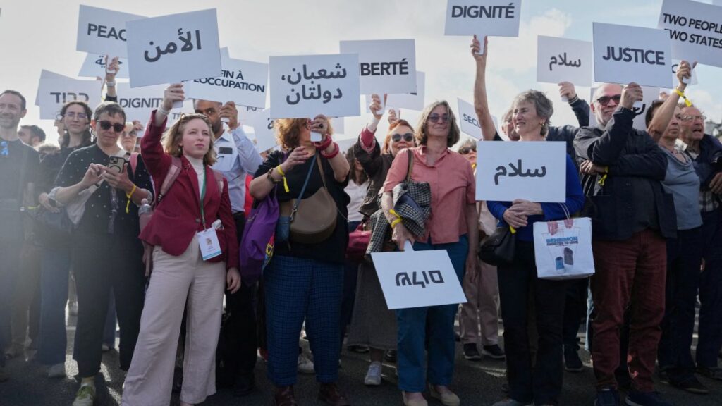 Participants in a conference with Israeli and Palestinian civil society groups supporting a two-state solution gather with placards on a bridge in support of a Palestinian state, in Paris, France, June 12, 2026. Thibault Camus/Pool via REUTERS