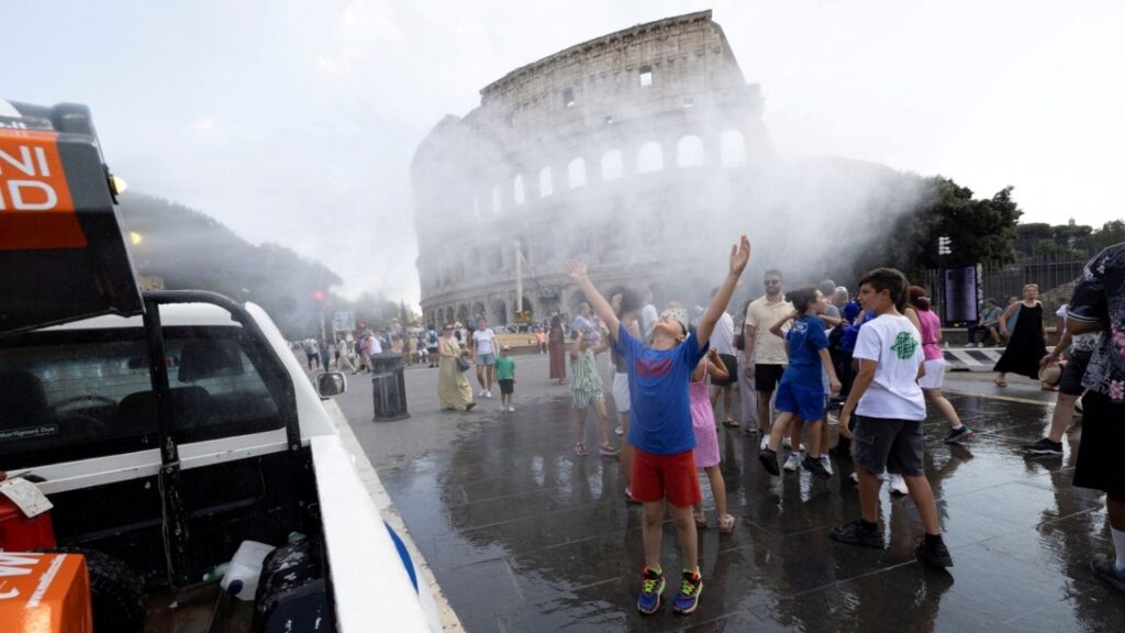 People cool off under a water mist near the Colosseum as Italy’s Civil Protection deploys measures to help residents and tourists cope with a heatwave, in Rome, Italy, June 26, 2026. (Reuters/Remo Casilli)