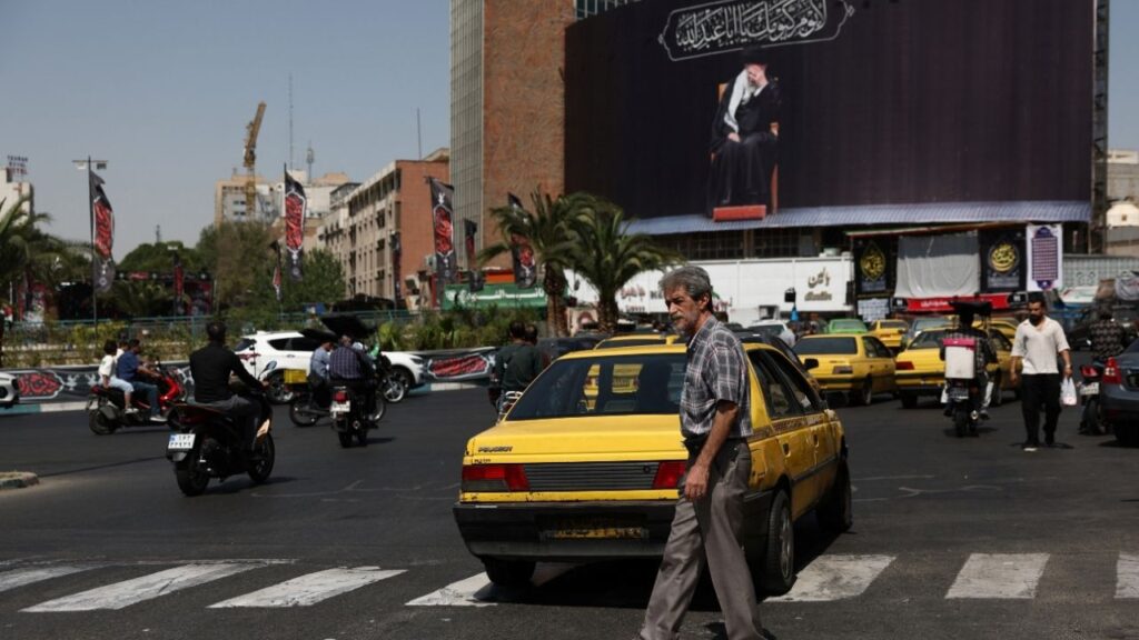 People move past a billboard with an image of Iran's late Supreme Leader Ayatollah Ali Khamenei in Tehran, Iran, June 30, 2026. Majid Asgaripour/WANA (West Asia News Agency) via REUTERS