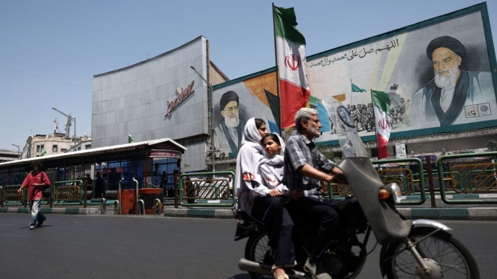 People ride past a mural depicting the late leader of the Islamic Revolution, Ayatollah Ruhollah Khomeini, and the late Iran's Supreme Leader Ayatollah Ali Khamenei, on a street in Tehran, Iran, June 9, 2026. Majid Asgaripour/WANA (West Asia News Agency) via REUTERS