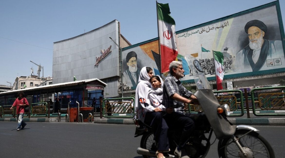 People ride past a mural depicting the late leader of the Islamic Revolution, Ayatollah Ruhollah Khomeini, and the late Iran's Supreme Leader Ayatollah Ali Khamenei, on a street in Tehran, Iran, June 9, 2026. Majid Asgaripour/WANA (West Asia News Agency) via REUTERS