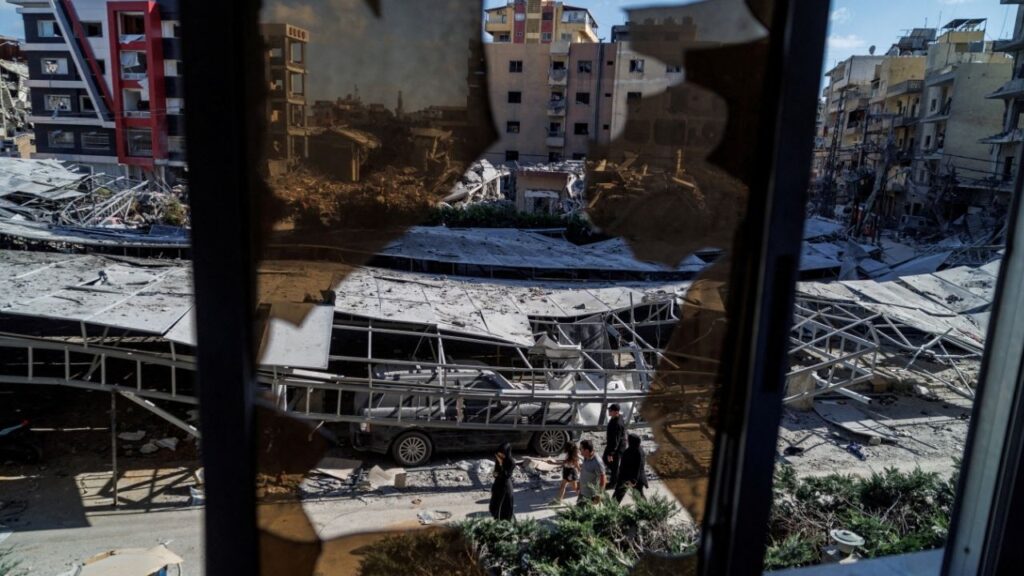 People walk past rubble at the site of an Israeli strike following a deal between the U.S. and Iran in Tyre, southern Lebanon, June 16, 2026. (Reuters/Zohra Bensemra)