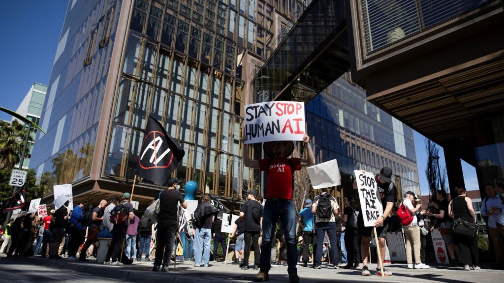 Protesters rally outside of the OpenAI headquarters before marching to the office of xAI, calling for a pause in AI development, in San Francisco, California, U.S., March 21, 2026. (Reuters File)