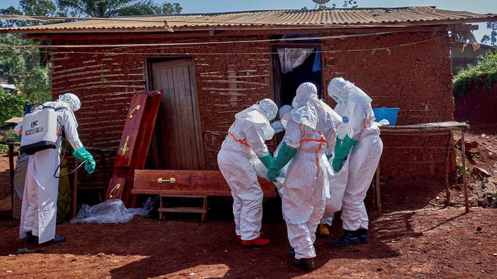 Red Cross workers wearing personal protective equipment (PPE) work at the house of an unidentified man who died of Ebola, to retrieve his body, as aid agencies intensify efforts to contain a new Ebola outbreak involving the Bundibugyo strain, in Quartier Shuni 1, a residential sector in Mongbwalu, Djugu Territory of Ituri province, Democratic Republic of the Congo, May 24, 2026. (Reuters/Gradel Muyisa Mumbere)