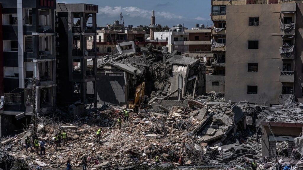 Rescue workers use an excavator as they search for people under the rubble of a building that was hit in an Israeli strike in the southern port city of Tyre, June 2, 2026. (Daniel Berehulak/The New York Times)