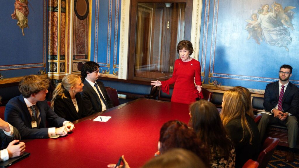 Sen. Susan Collins (R-Maine) welcomes a group of students from her state to Capitol Hill in Washington on May 21, 2026. Collins, who is in the middle of a tumultuous re-election race, has become the first senator in history to reach the threshold of 10,000 consecutive votes cast. (Haiyun Jiang/The New York Times)
