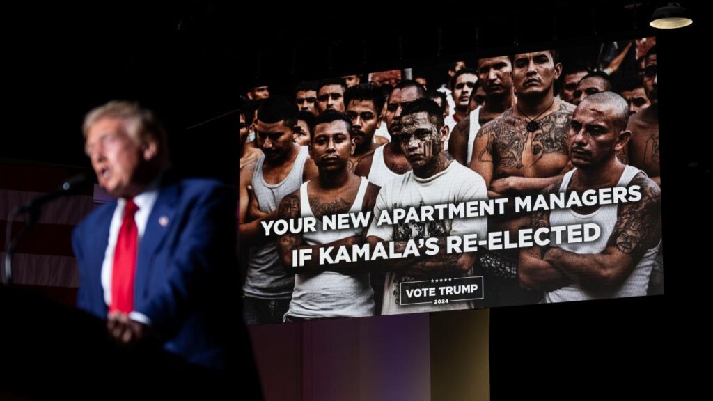 Image of Donald Trump speaking at a campaign rally and trying to incite fear with pictures of alleged immigrant gang members