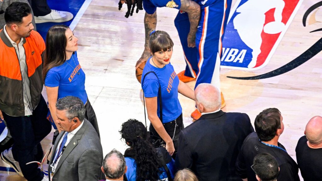 Taylor Swift, center, is followed by Alana Haim as they arrive for Game 4 of the NBA Finals between the New York Knicks and the San Antonio Spurs at Madison Square Garden in Manhattan on Wednesday, June 10, 2026. Swift was seated courtside at Wednesday night’s Knicks game, wearing a quirky take on Knicks gear and accompanied by the musicians Alana and Este Haim. (Vincent Alban/The New York Times)