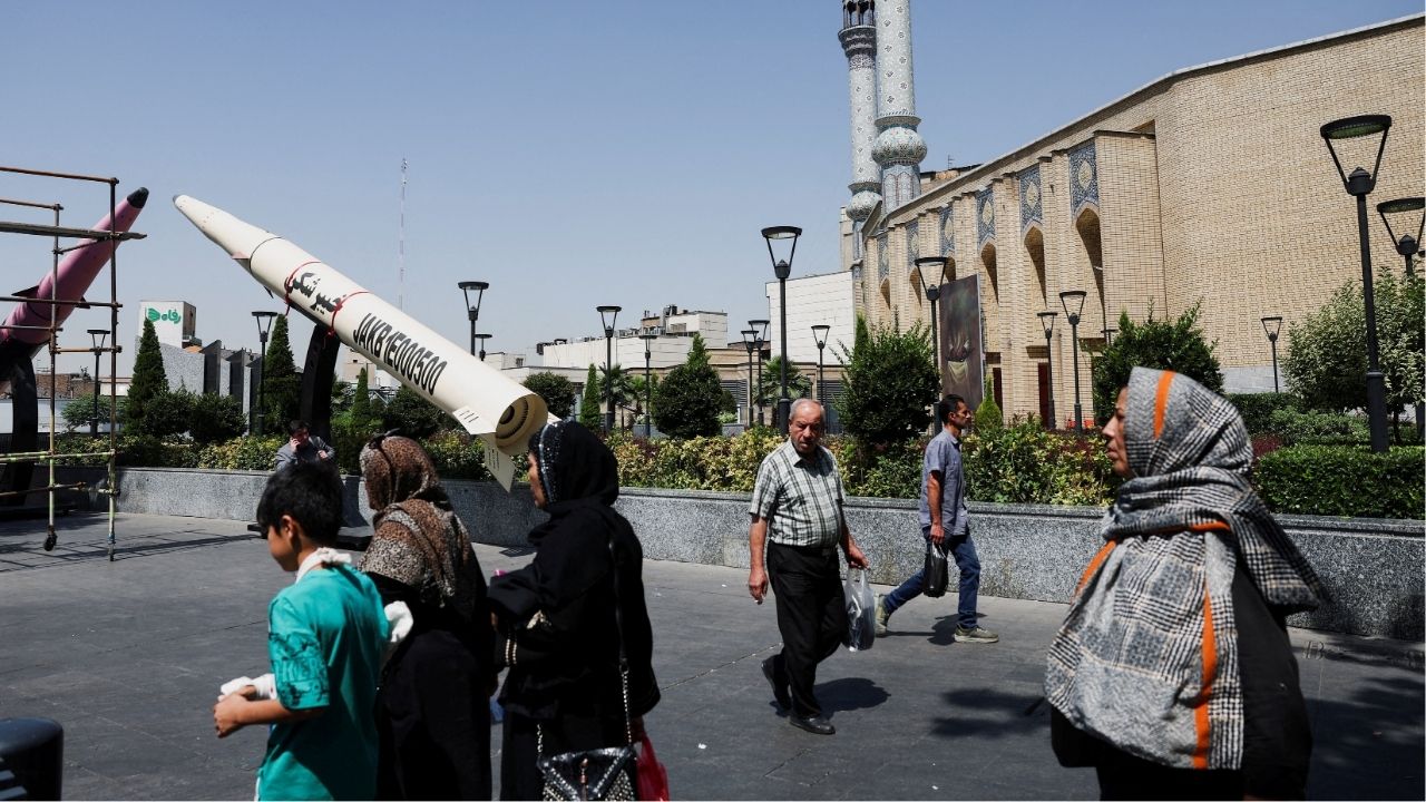 People walk next to a symbolic mock-up of an Iranian missile, on a street in Tehran, Iran, June 11, 2026. Majid Asgaripour/WANA (West Asia News Agency) via Reuters