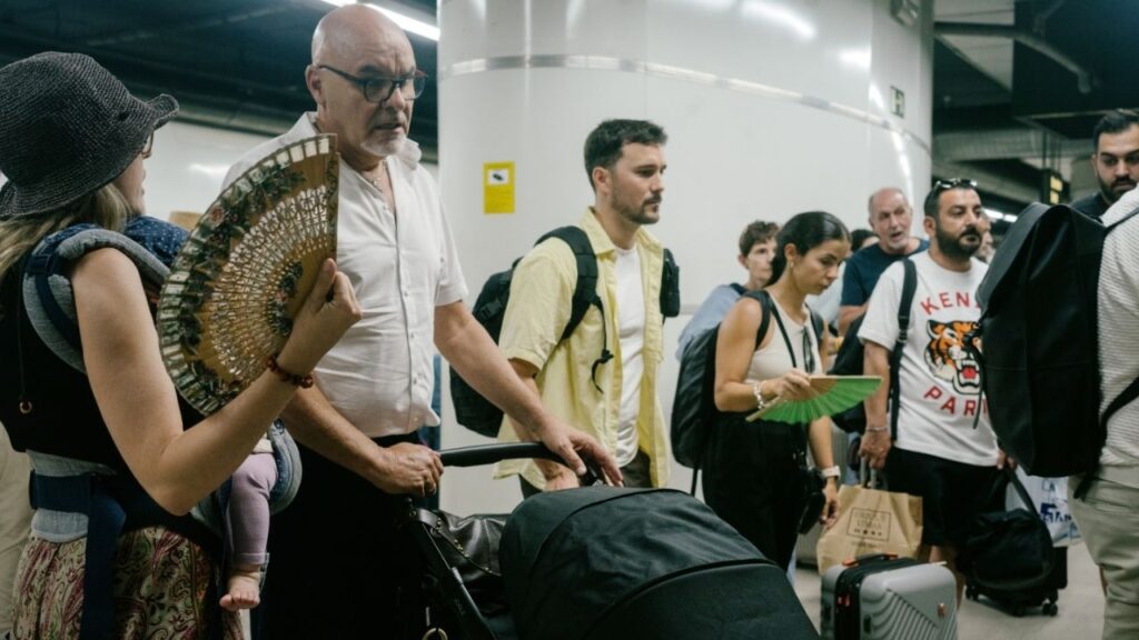 Train passengers use hand fans to cool off as they wait to board at the Sants Station in Barcelona, Spain on Thursday, June 25, 2026. As Europe broils under record-shattering temperatures that are testing the continent’s ability to adapt to extreme weather, Spain on Thursday warned of a possible spike in heat-related deaths. (Samuel Aranda/The New York Times)