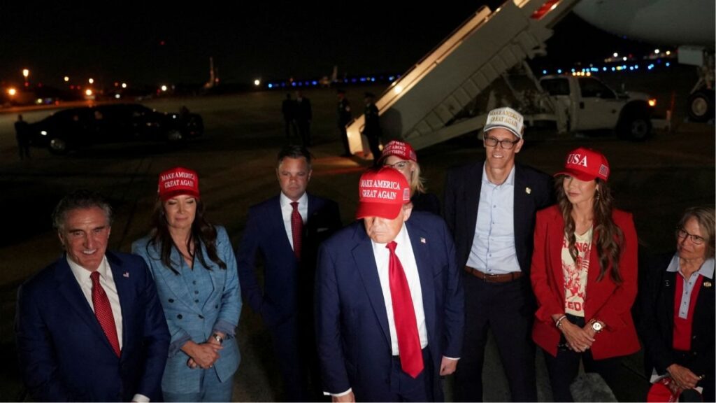 U.S. President Donald Trump stands with U.S. Homeland Security Secretary Kristi Noem, Agriculture Secretary Brooke Rollins, Interior Secretary Doug Burgum, Representative Randy Feenstra (R-IA), Representative Zach Nunn (R-IA), Rep. Mariannette Miller-Meeks (R-IA) and Representative Ashley Hinson (R-IA), upon arrival at Joint Base Andrews following a visit to Iowa, at Joint Base Andrews, Maryland, U.S. July 4, 2025. (Reuters File)