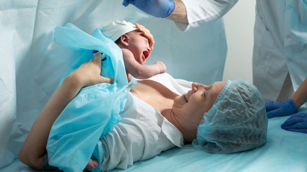 Image of a newborn and mother in a hospital