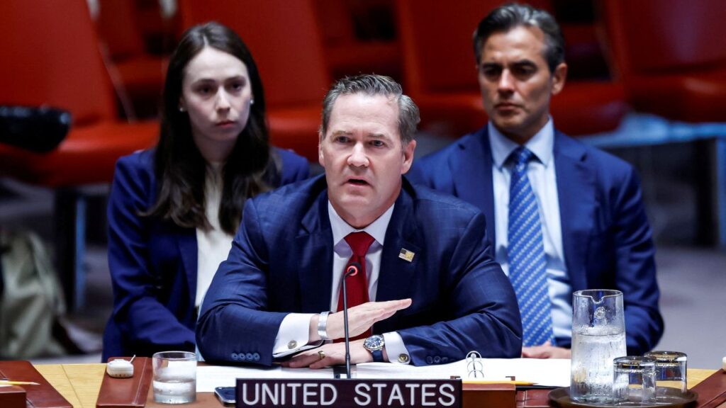 Image of Ambassador Mike Waltz , in a blue suit, white shirt, and red tie, sitting at a table and addressing the UN