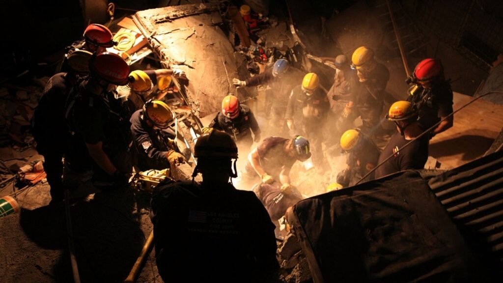 A Los Angeles County Fire Department Search and Rescue Team works on Jan. 15, 2010, to extract three women trapped in a collapsed building after the earthquake in downtown Port-au-Prince, Haiti. In 2010, there was a huge U.S. aid effort after a quake in Haiti. Today, U.S. officials say they oversee billions in Venezuelan oil revenue, but aid is less. (Damon Winter/The New York Times)
