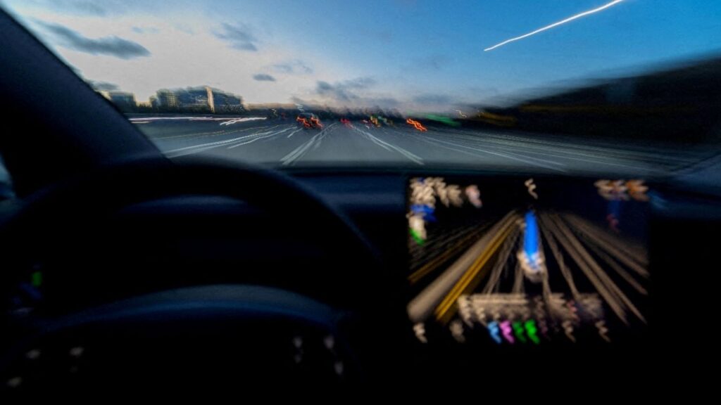 A display of a Tesla Model 3 using Full Self-Driving Supervised on a highway in San Diego, California, U.S., April 15, 2026. Picture taken with a long exposure. (Reuters File)