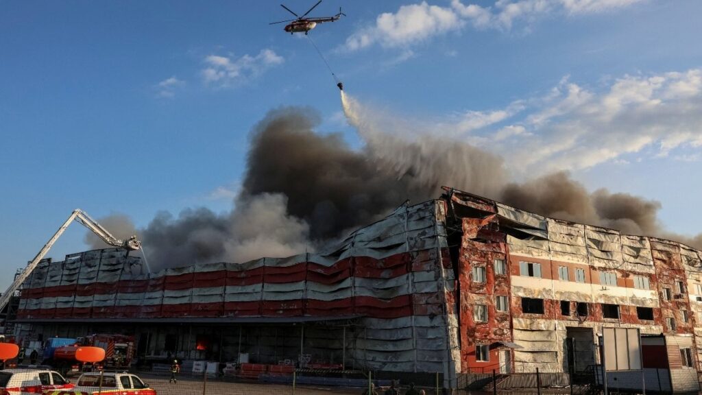 A firefighting helicopter drops water over the site of a Russian missile strike, amid Russia's attack on Ukraine, in Kyiv region, Ukraine July 19, 2026. REUTERS/Anatolii Stepanov