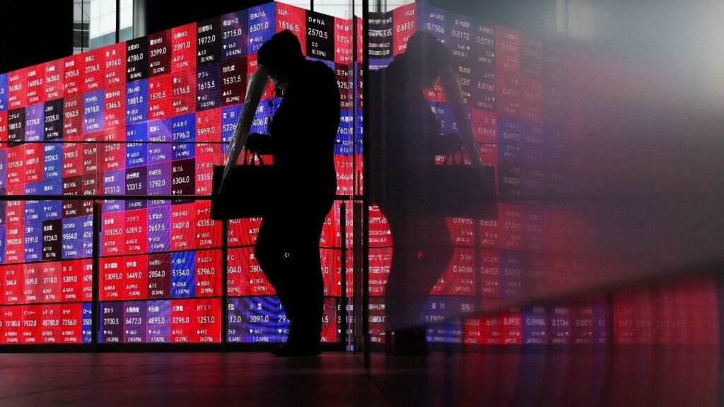 A man walks in front of an electronic screen displaying Japan's Nikkei stock prices quotation board inside a conference hall in Tokyo, Japan, April 27, 2026. (Reuters File)