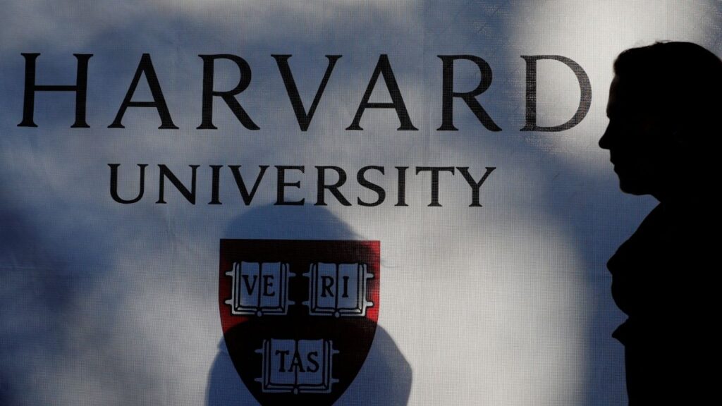 A pedestrian walks past a Harvard University sign after U.S. President Donald Trump said that his administration was close to a deal with Harvard University, in Cambridge, Massachusetts, U.S., September 30, 2025. (Reuters File)