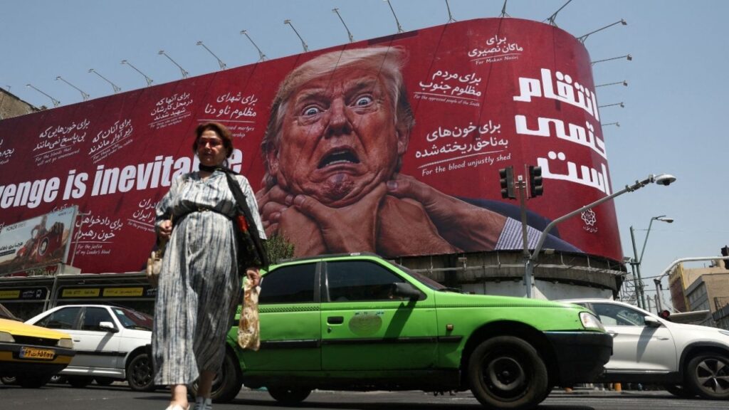 A woman walks near a billboard depicting U.S. President Donald Trump on a building in Tehran, Iran, July 27, 2026. Majid Asgaripour/WANA (West Asia News Agency) via REUTERS