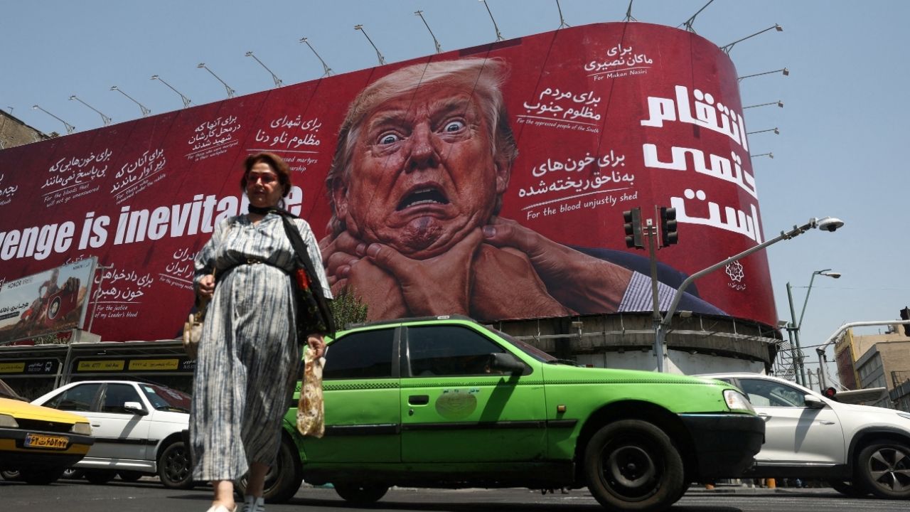 A woman walks near a billboard depicting U.S. President Donald Trump on a building in Tehran, Iran, July 27, 2026. Majid Asgaripour/WANA (West Asia News Agency) via REUTERS