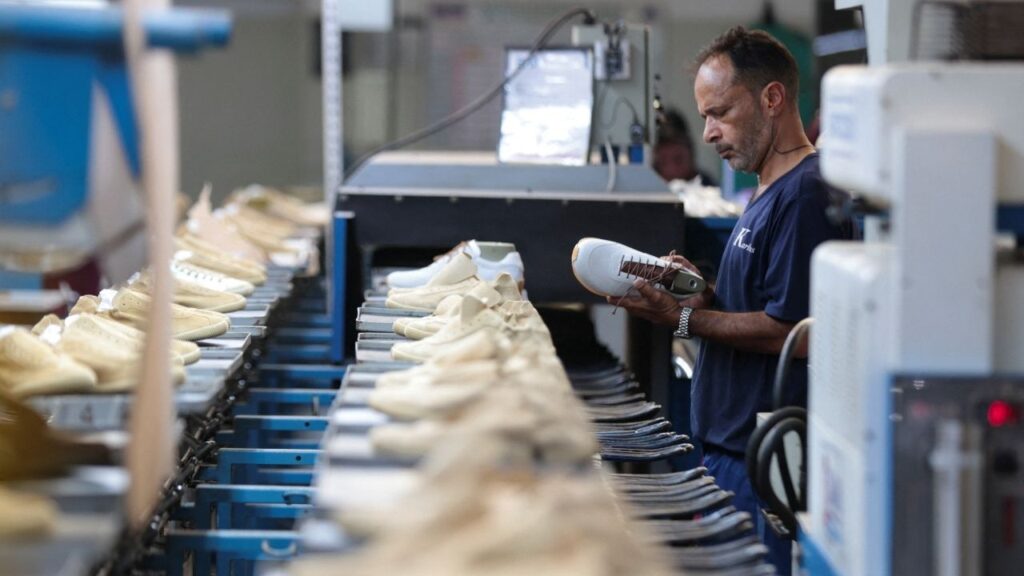 A worker inspects a shoe on a production line at Brazilian footwear manufacturer Kissol, as new U.S. tariffs are set to hit a range of Brazilian goods, including the footwear industry, which counts the U.S. as its top foreign market, in Franca, Sao Paulo state, Brazil, July 17, 2026. (Reuters/Joel Silva)