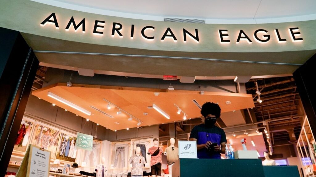 An American Eagle Outfitters employee waits for customers at a cleaning station outside a store in Arlington, Virginia, U.S., June 1, 2021. (Reuters File)